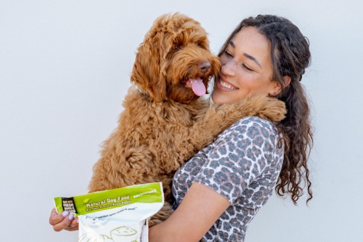 Light brown dog in arms of woman, featured on My Perfect Pet