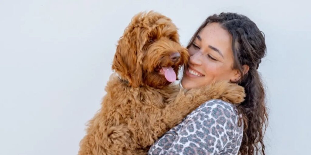 Pet parent hugging dog, happy days